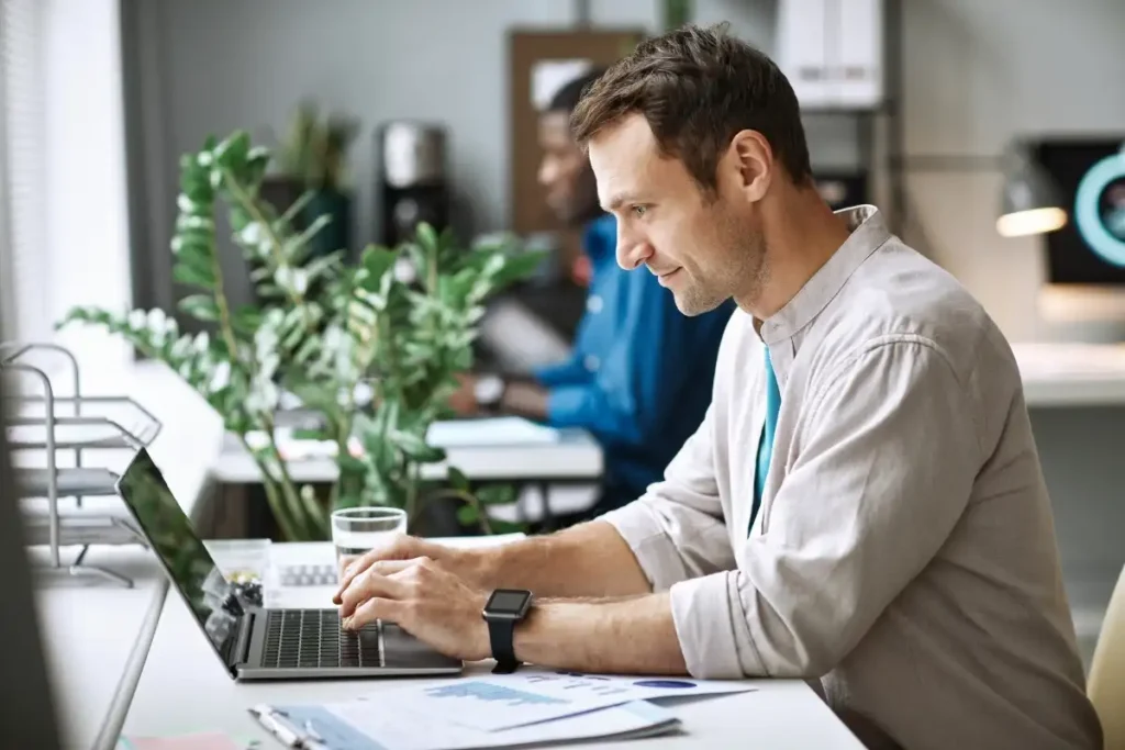 Male worker on a laptop in the office